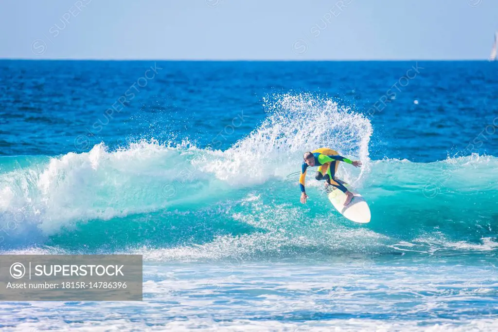 Teenage boy surfing in the sea