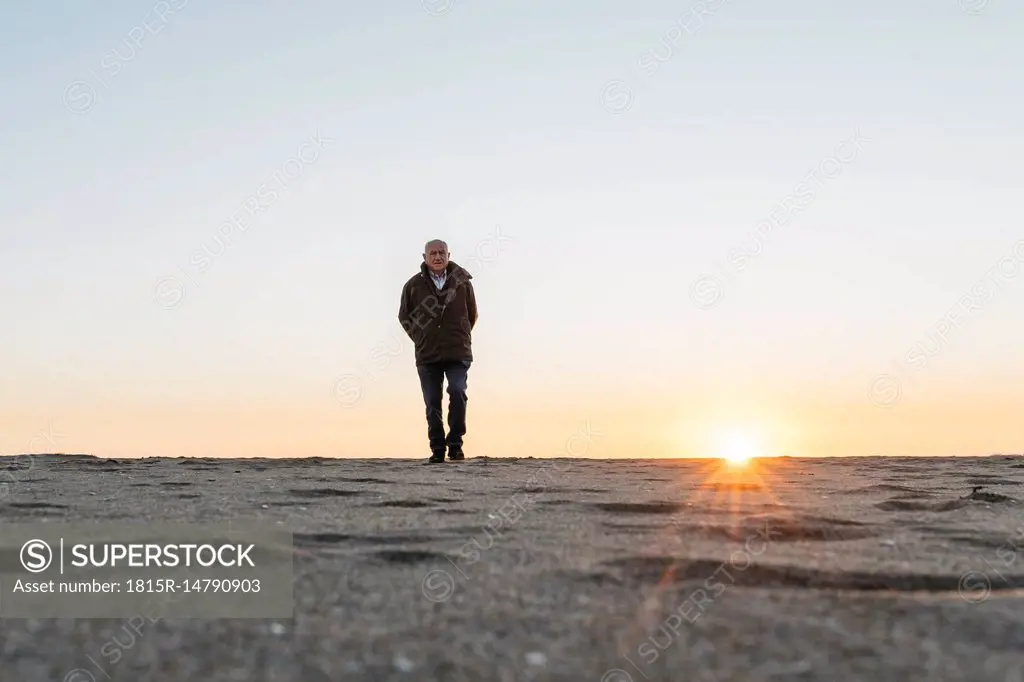 Senior man strolling at the beach