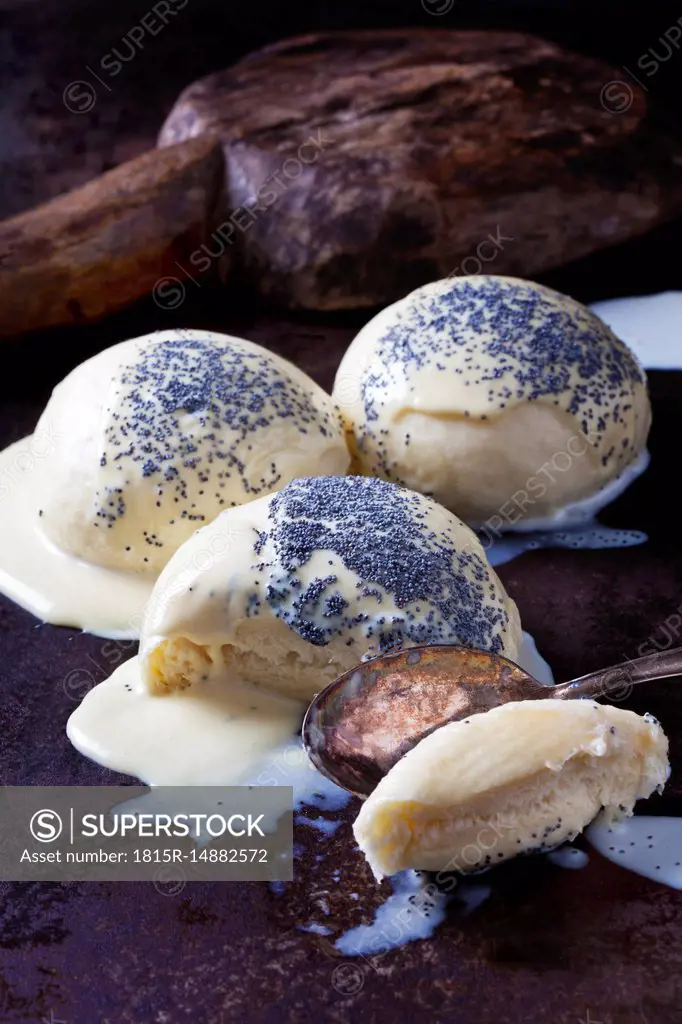 Yeast dumplings with vanilla sauce sprinkled with poppy seed