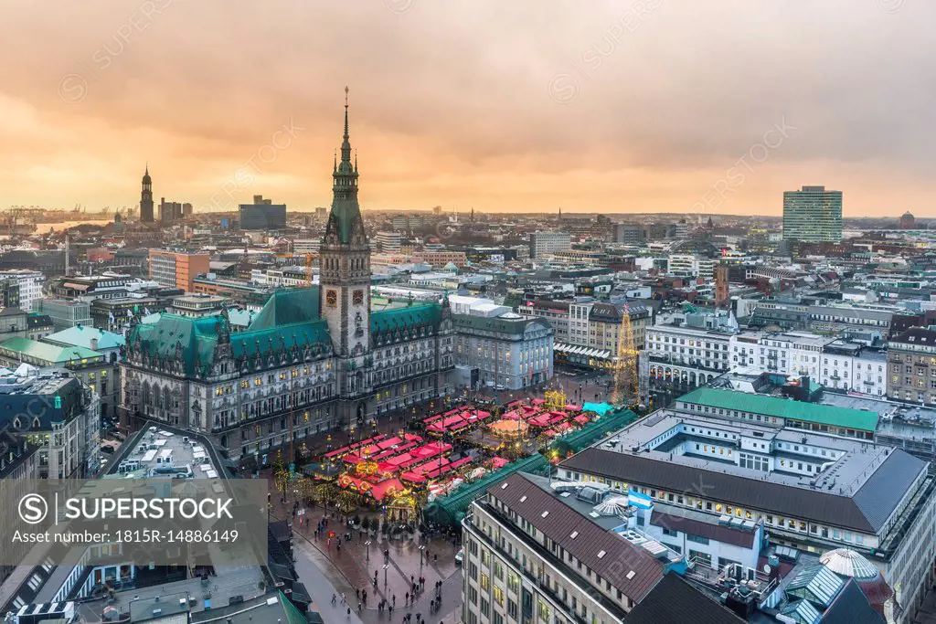 Germany, Hamburg, Christmas market at town hall in the evening