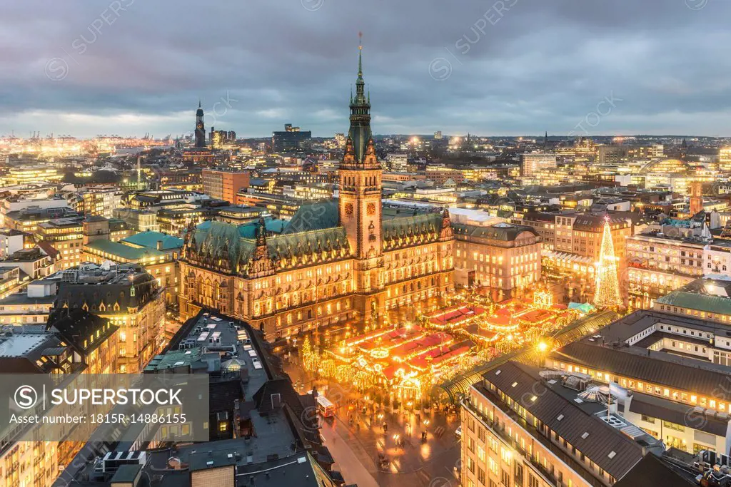 Germany, Hamburg, Christmas market at town hall in the evening