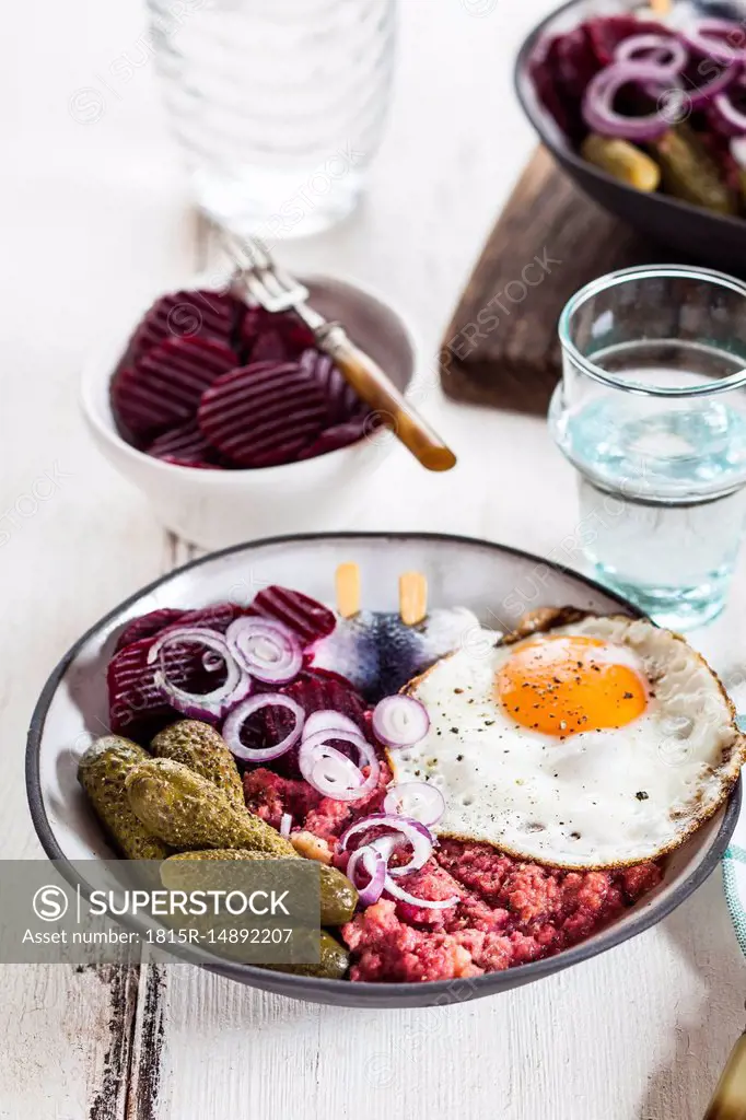 Labskaus, rollmops, pickled gherkin, beetroot salad, onion and fried egg