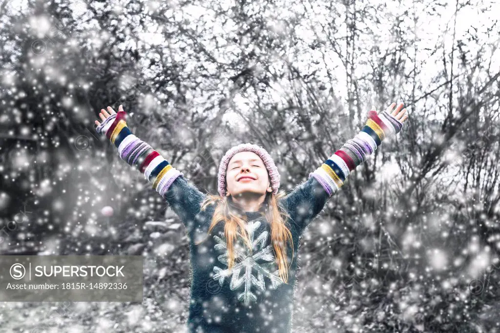 Happy girl at snowfall