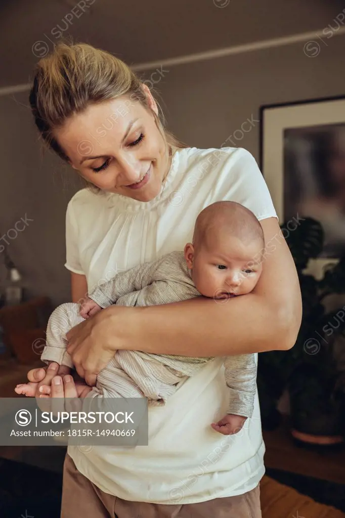 Newborn baby being held in motherƒ.s arms