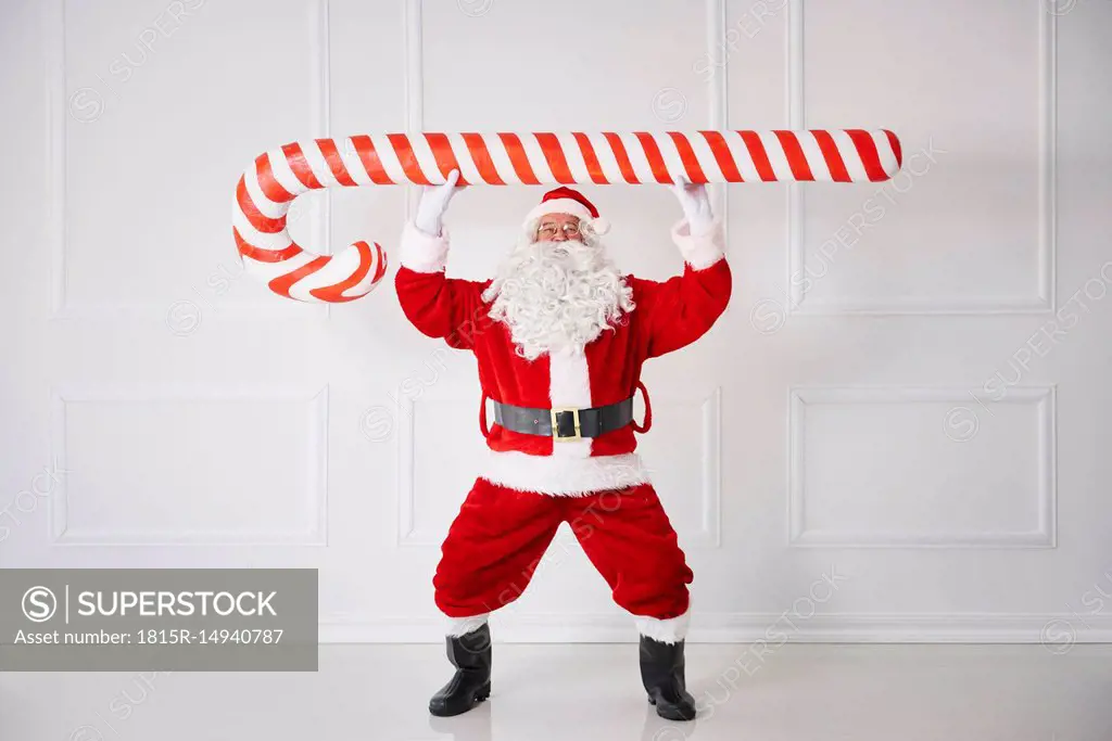 Santa Claus with oversized candy cane