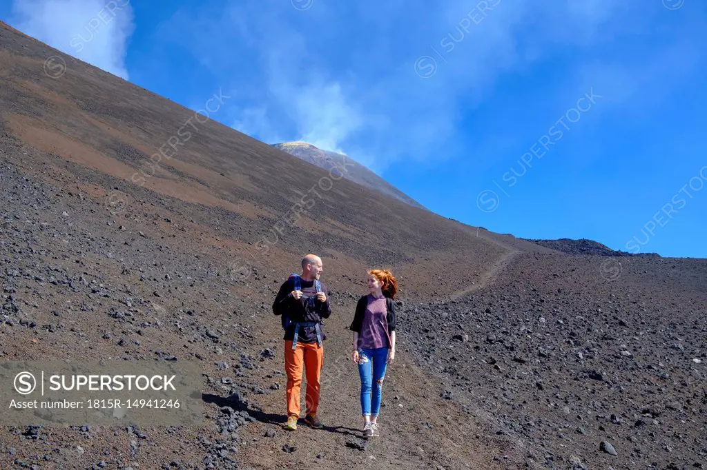 Italy, Sicily, Mount Etna, father and daughter hiking