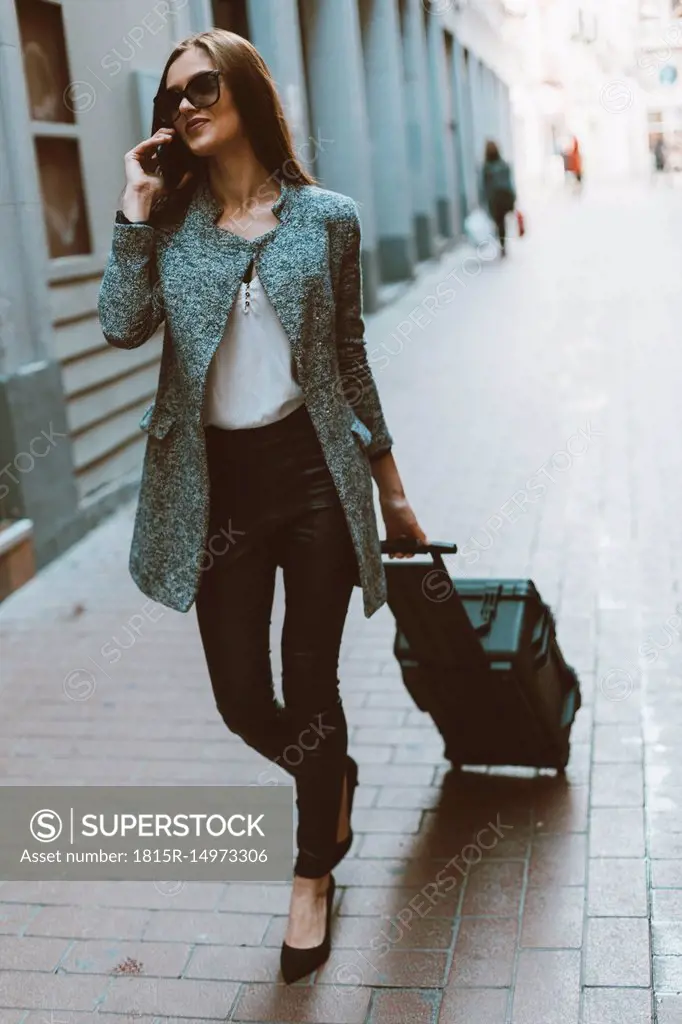 Young tourist on the phone walking down the street