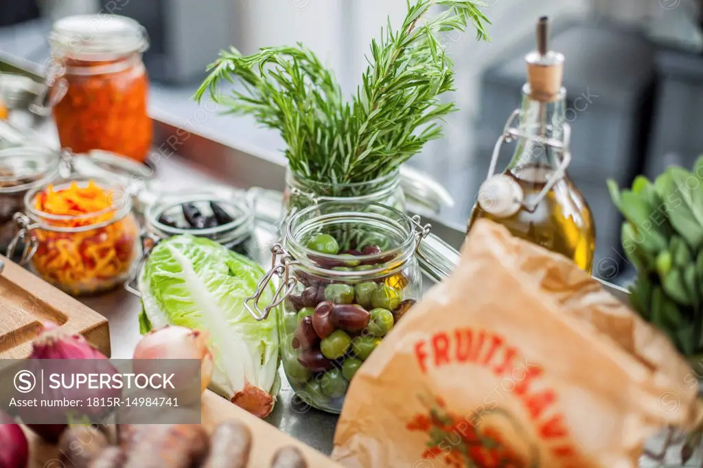 Different ingredients, green olives in glass