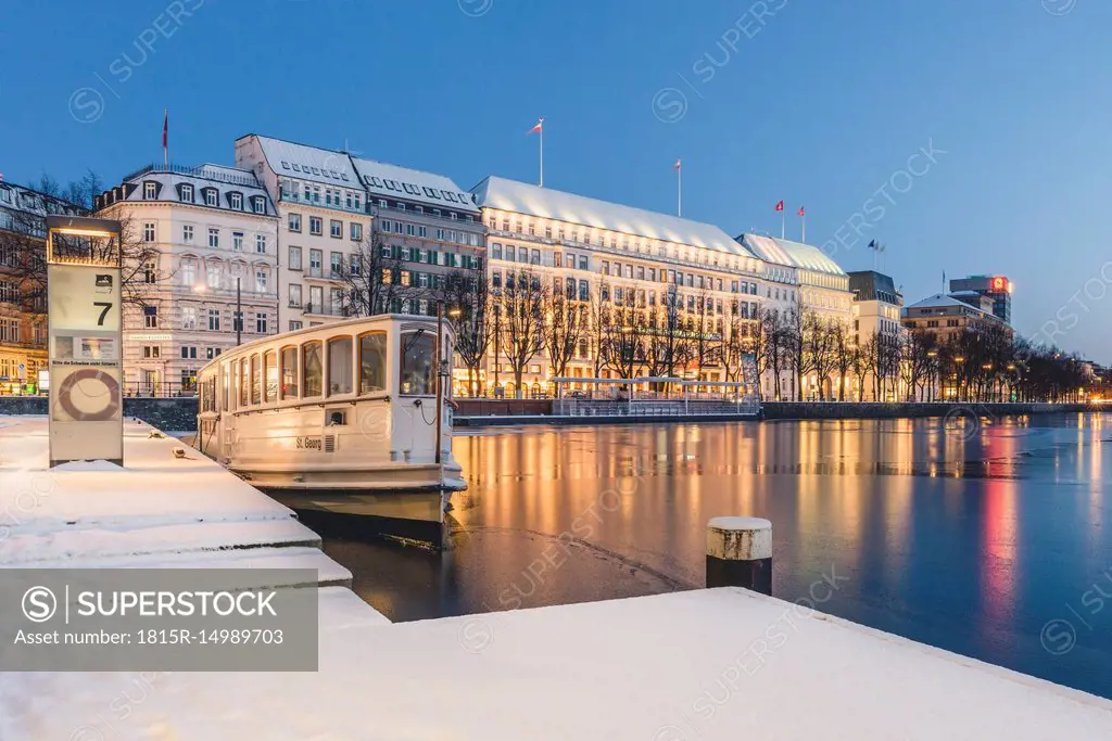 Germany, Hamburg, Inner Alster Lake and tourboat in winter