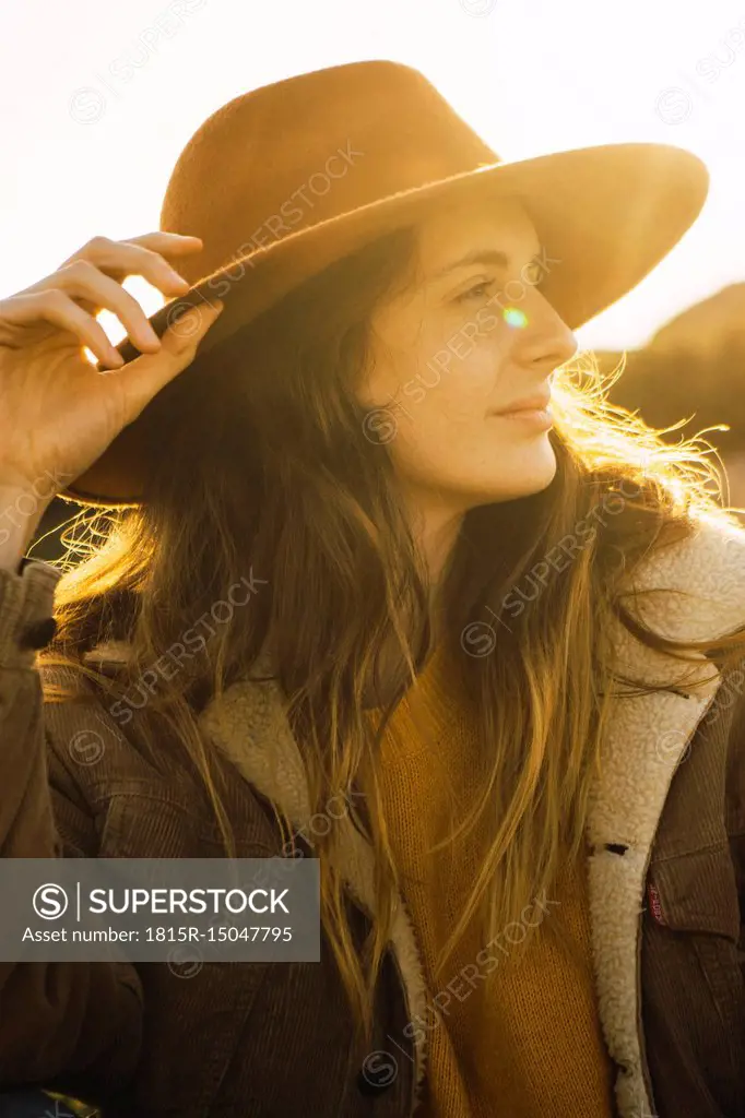 Italy, Sardinia, portrait of woman on a hiking trip at sunset