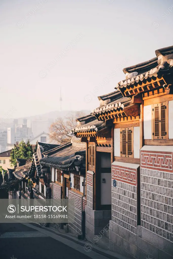 South Korea, Bukchon Hanok Village, street with traditional houses, Seoul Tower in the background