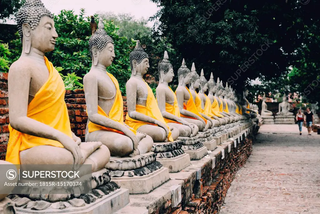 Thailand, Bangkok, Ayutthaya, Buddha statues in a row in Wat Yai Chai Mongkhon