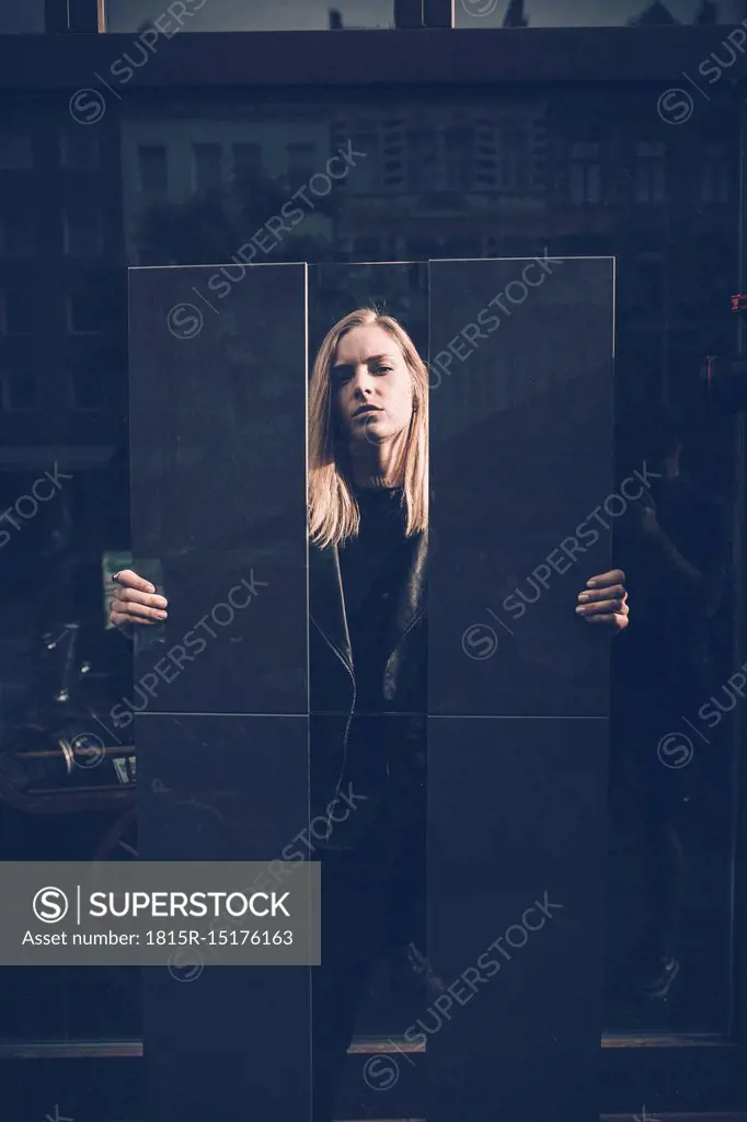 Portrait of serious young woman dressed in black