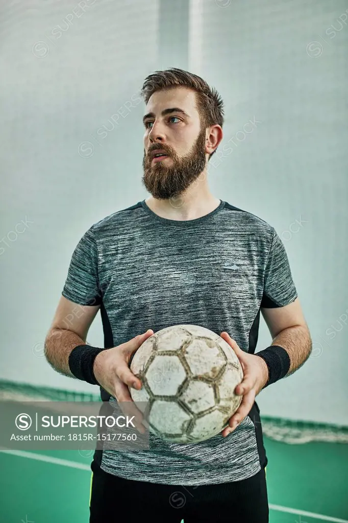 Portrait of indoor soccer player holding the ball