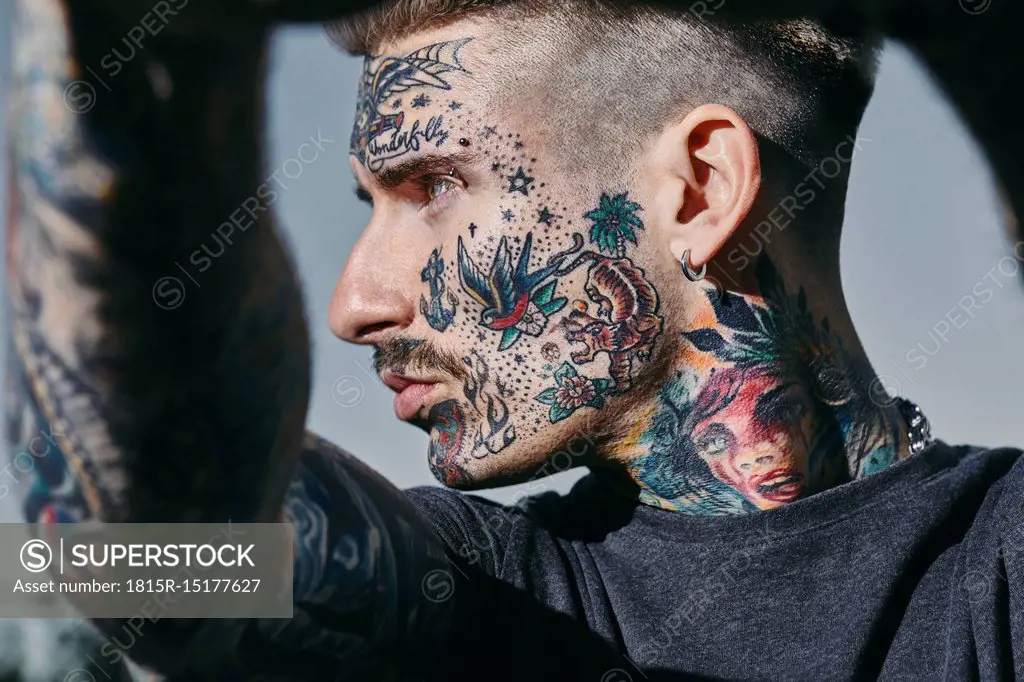 Portrait of tattooed young man outdoors