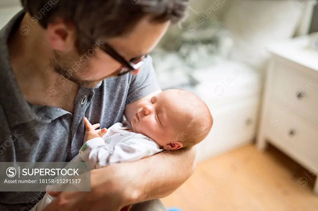 Father at home with his baby daughter