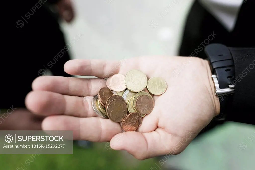 Euro coins in the hand of a businessman