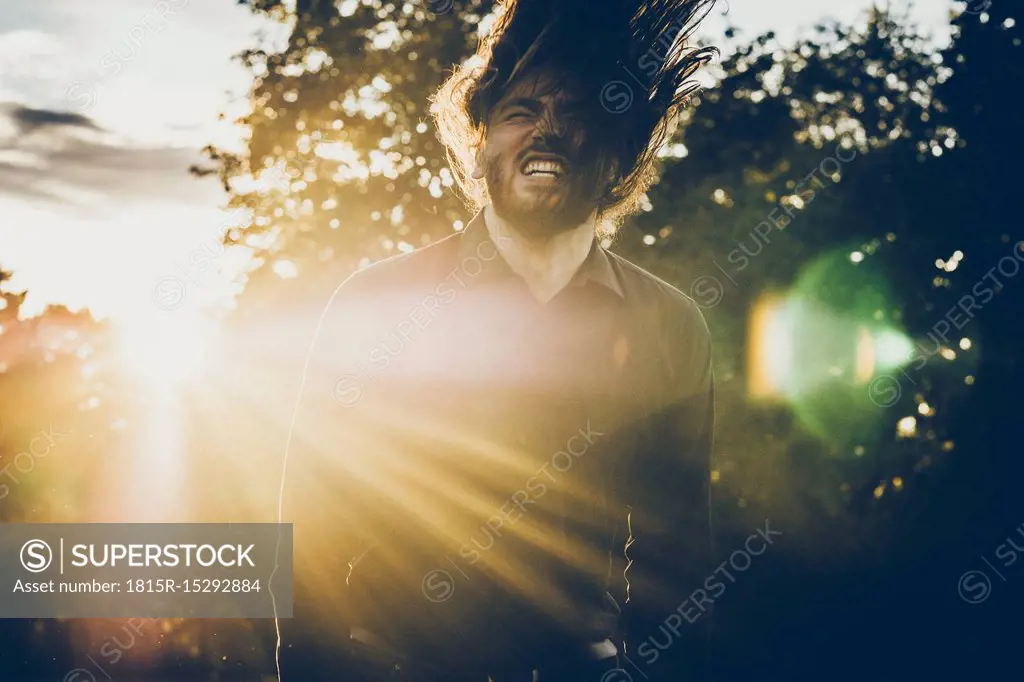 Heavy metal fan headbanging in a park