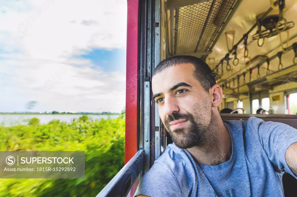 Thailand, Bangkok, tourist travelling by local train