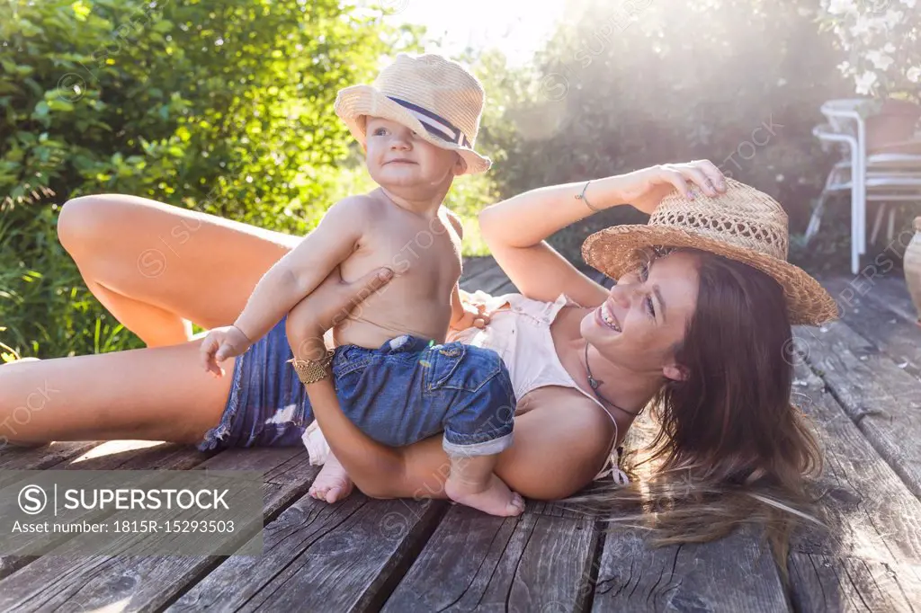 Mother and baby boy having fun on terrace