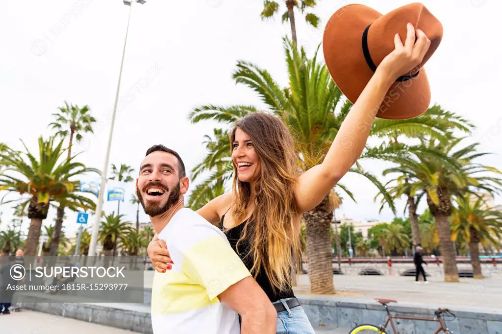 Spain, Barcelona, couple having fun on seaside promenade