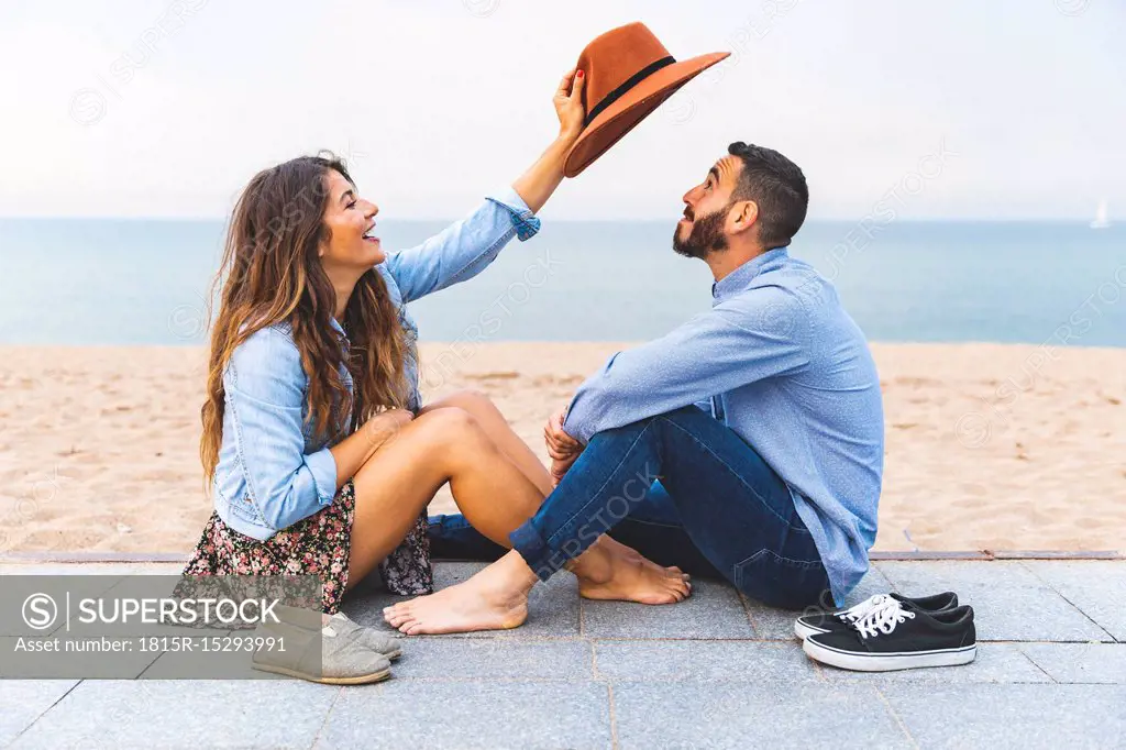 Spain, Barcelona, couple having fun together on the beach