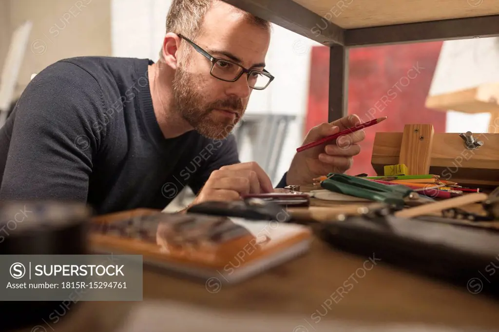 Man in artist's studio checking supplies