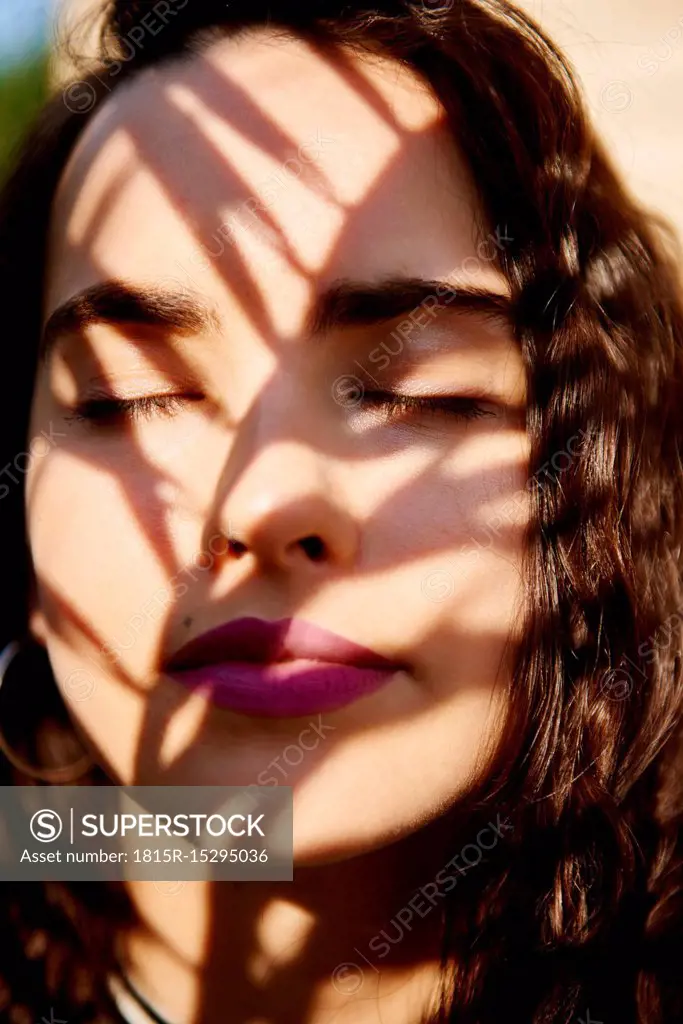 Young woman's face in sunlight