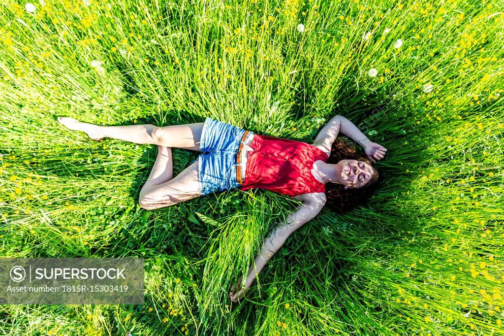 Young woman relaxing in meadow