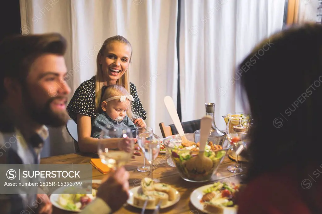 Family and friends enjoying dinner, eating, drinking, having fun