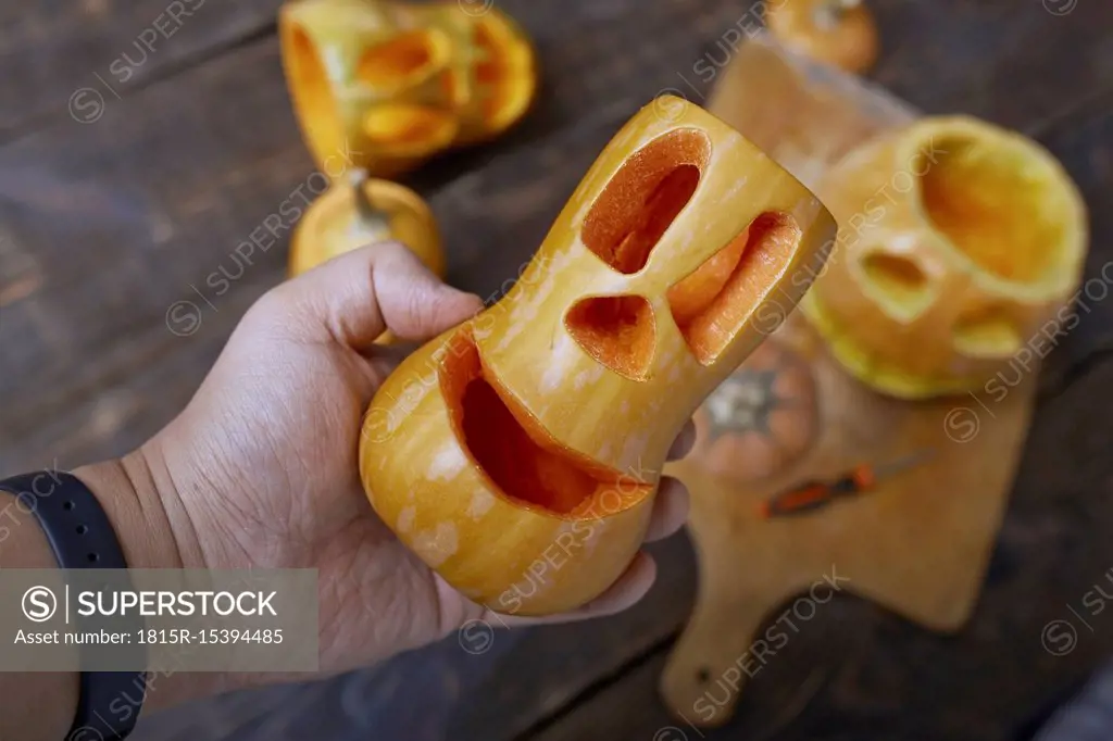 Man holding carved Halloween pumpkin