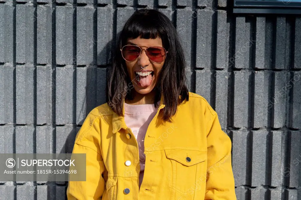 Portrait of young woman, wearing yellow jeans jacket