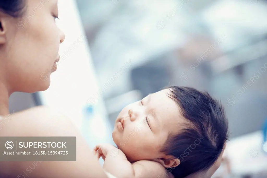 Portrait of baby girl hold by her mother