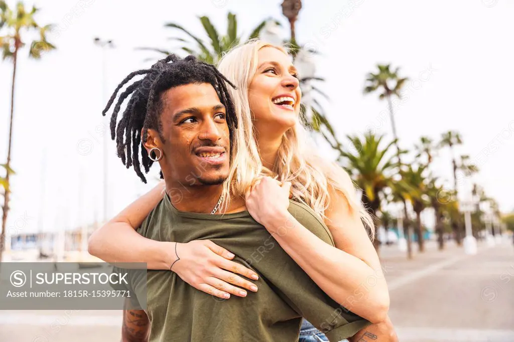 Spain, Barcelona, portrait of multicultural young couple on promenade