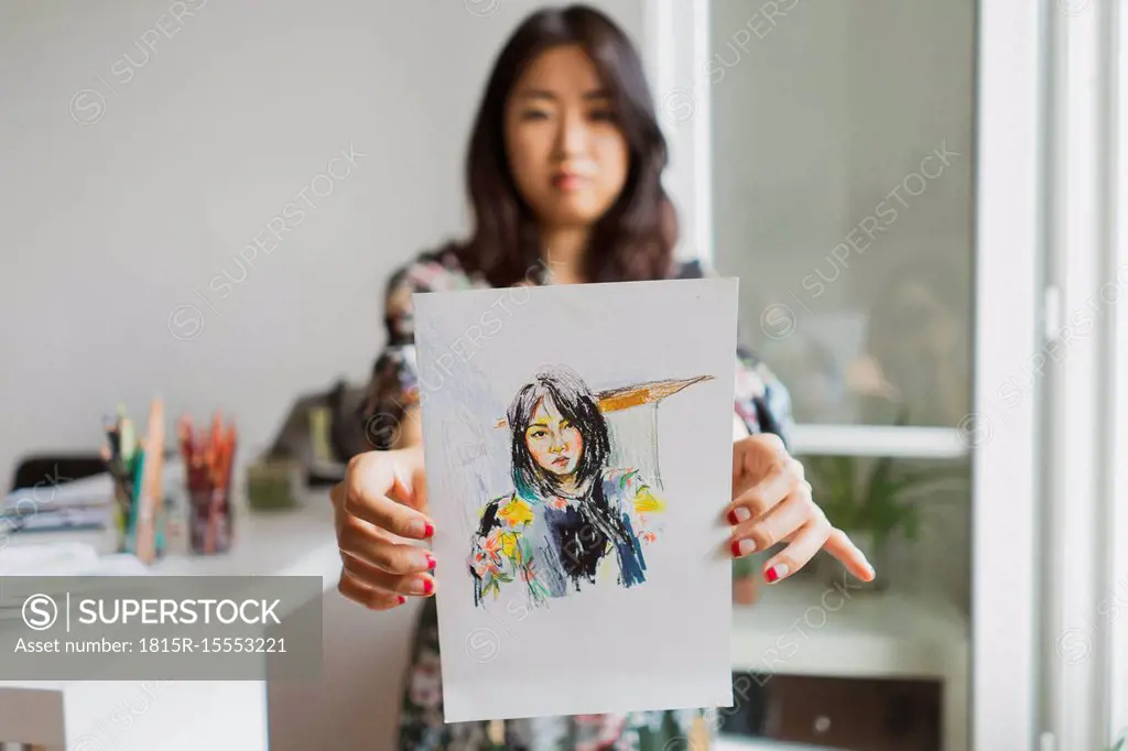 Illustrator showing drawing with self-portrait