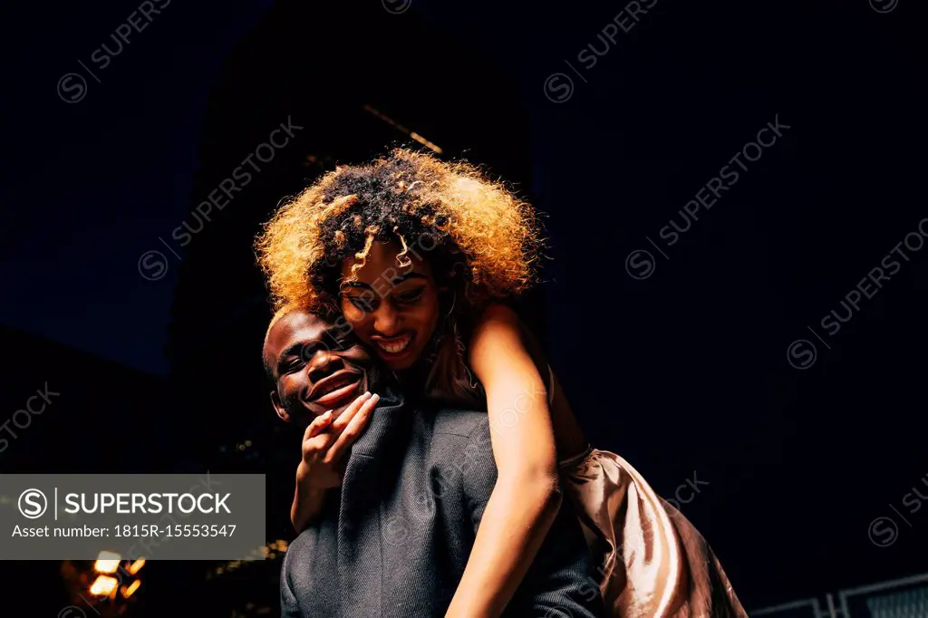 Young couple having fun together at night outdoors