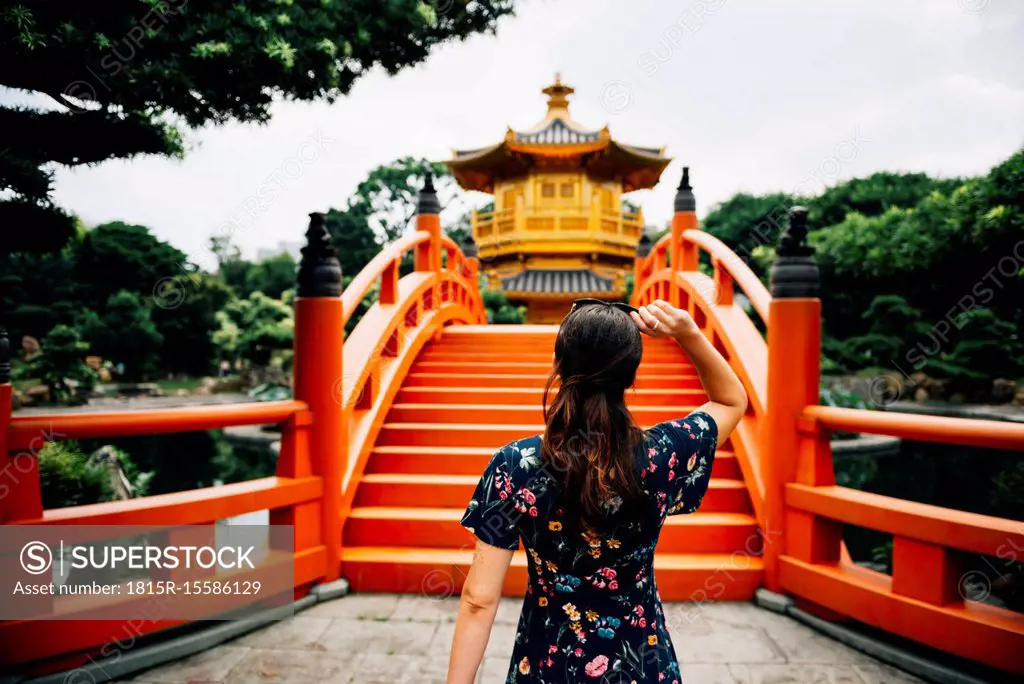 China, Hong Kong, Diamond Hill, Nan Lian Garden, Female tourist lookint at Golden Pavilion of Absolute Perfection