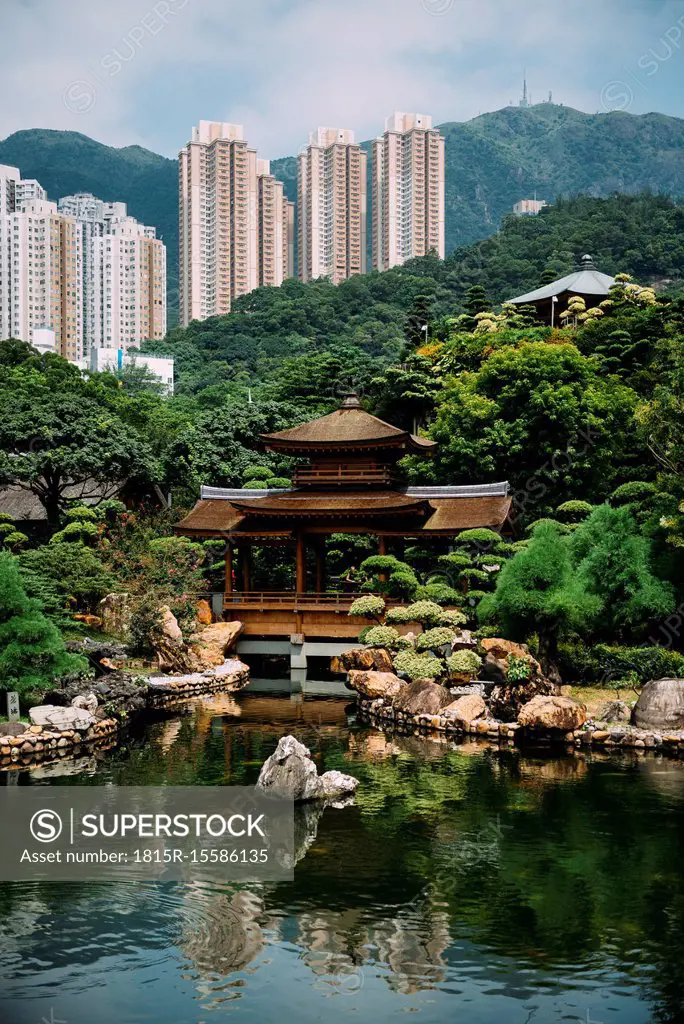 China, Hong Kong, Diamond Hill, Pond in Nan Lian Garden surrounded by skyscrapers