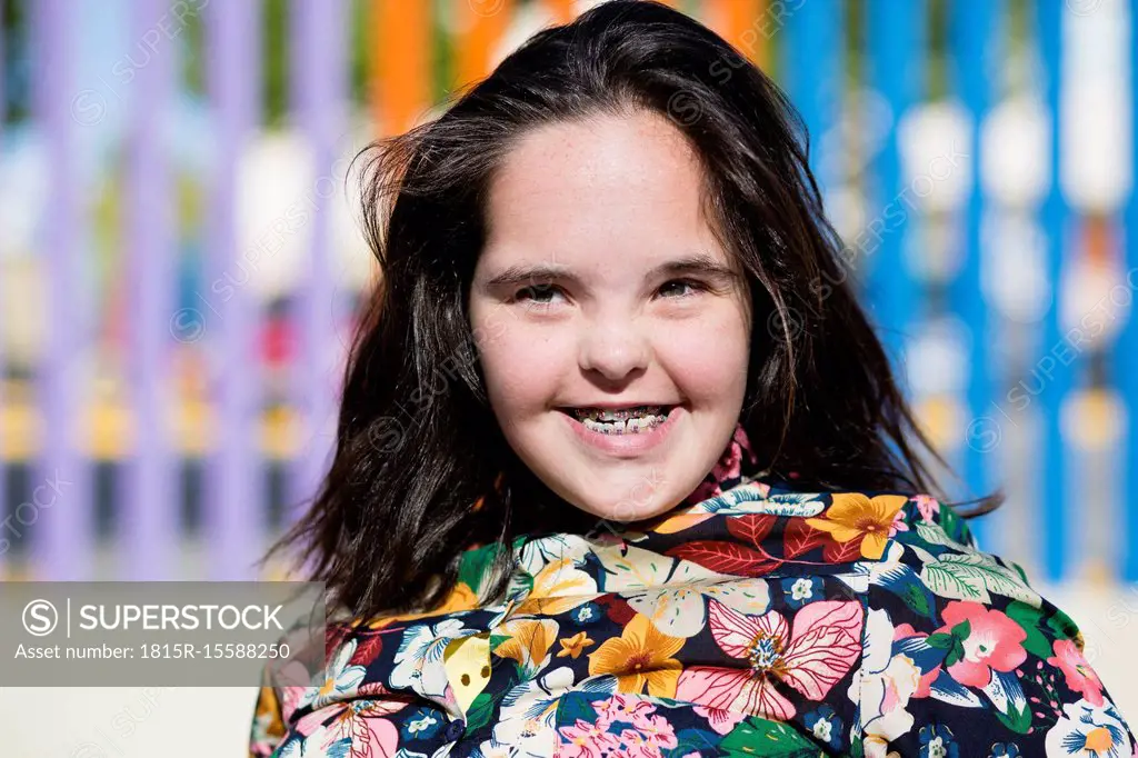 Teenager girl with down syndrome smiling, braces