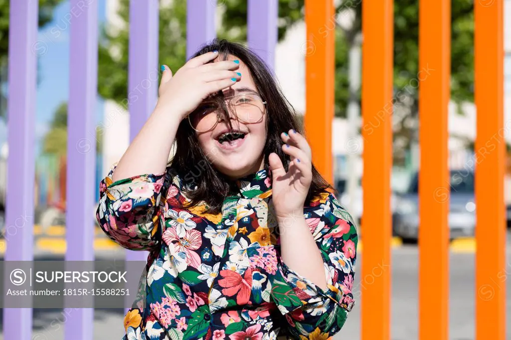 Teenager girl with down syndrome wearing glasses and smiling