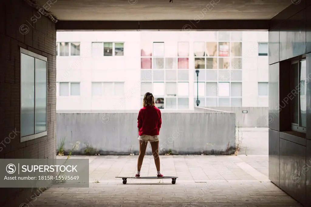 Young woman with her long board in a residential area