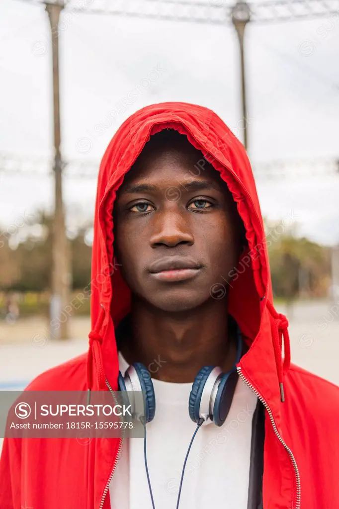 Portrait of a young black man wearing red hoodie