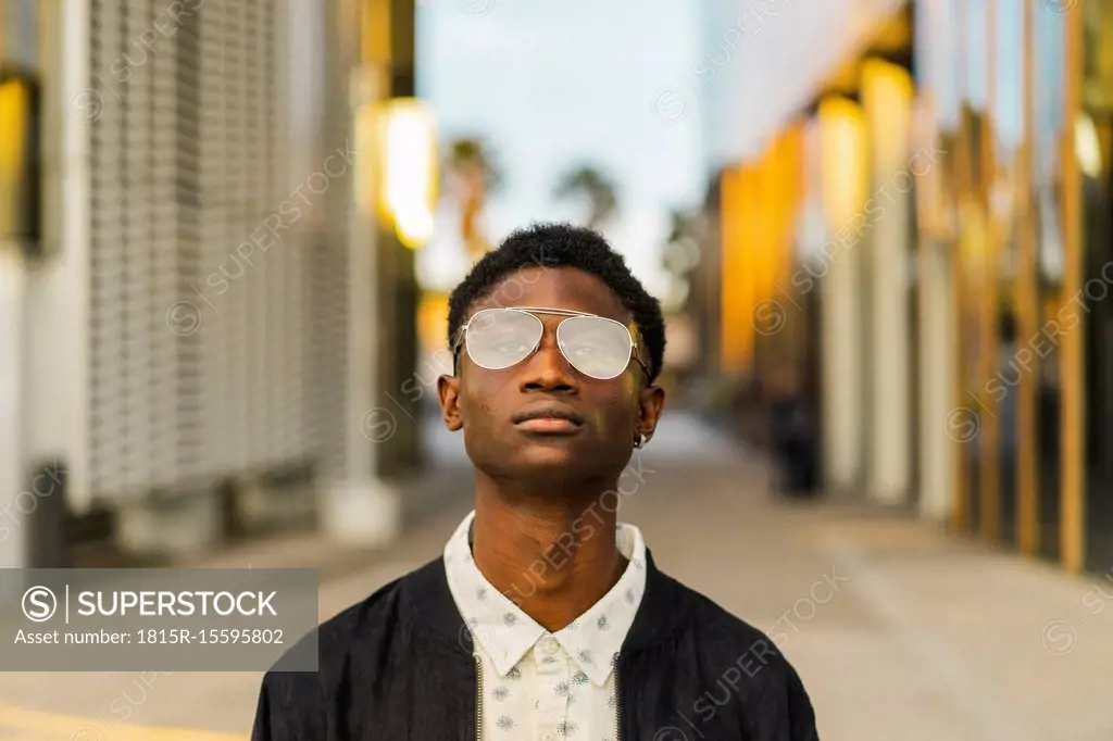 Portrait of a young black man, wearing a glasses