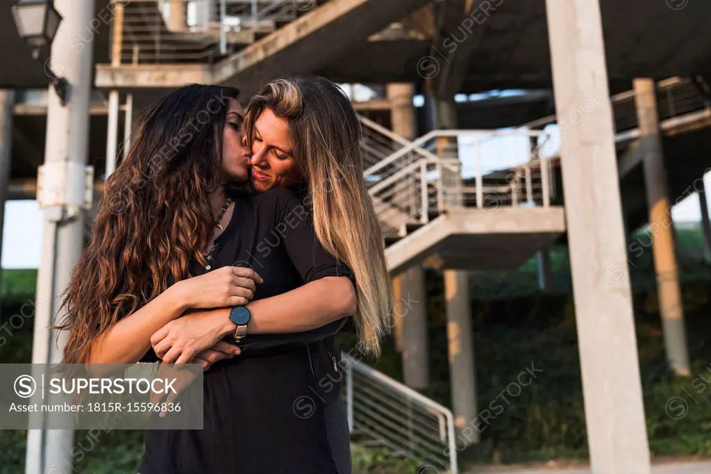 Lesbian couple kissing outdoors