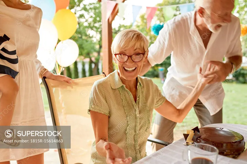 Exuberant senior couple on a garden party