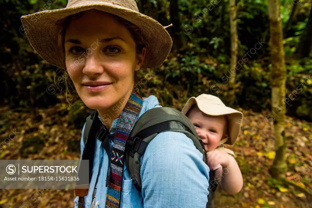 Japan, Okinawa, Woman hiking with her baby through the Unesco world heritage sight, sacred site Sefa Utaki