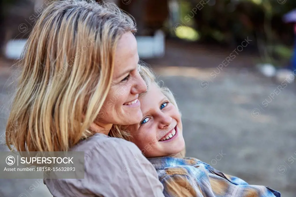Portrait of happy mother with son outdoors