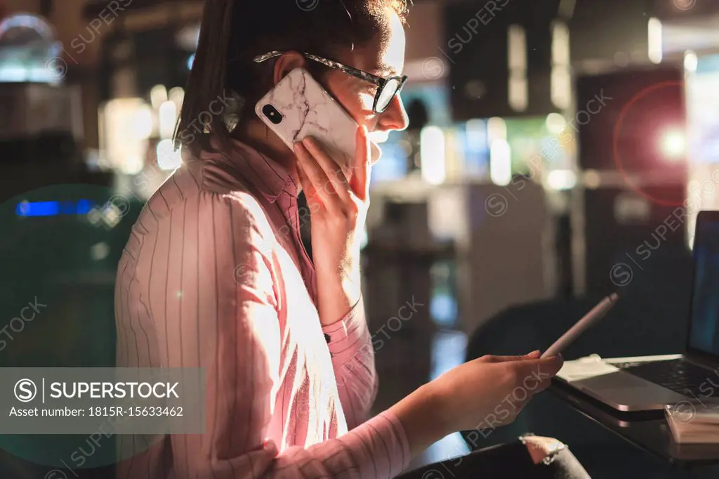 Woman working long hours, sitting in a coffee shop