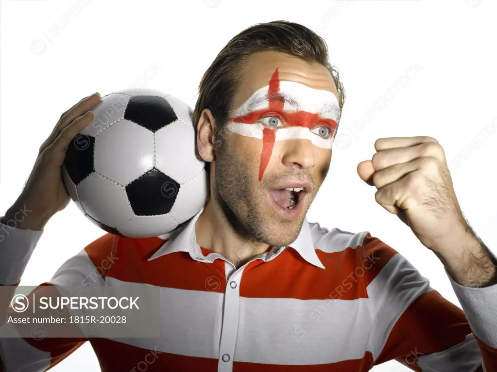 Man with English flag painted on face, shouting, portrait