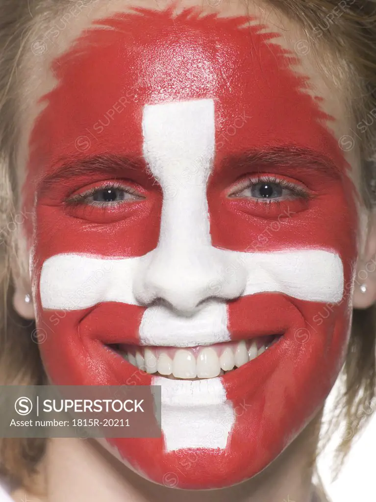 Man with Swiss flag painted on face, close-up, portrait